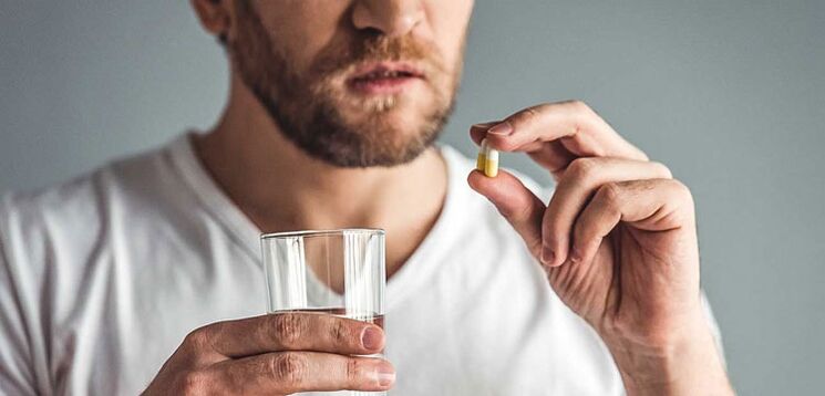 A man takes medication to treat prostatitis. 